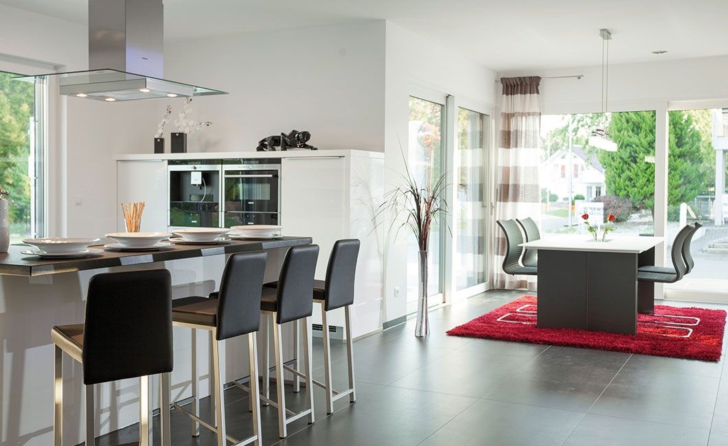 White kitchen with gray bar stools in the house Wolf-haus