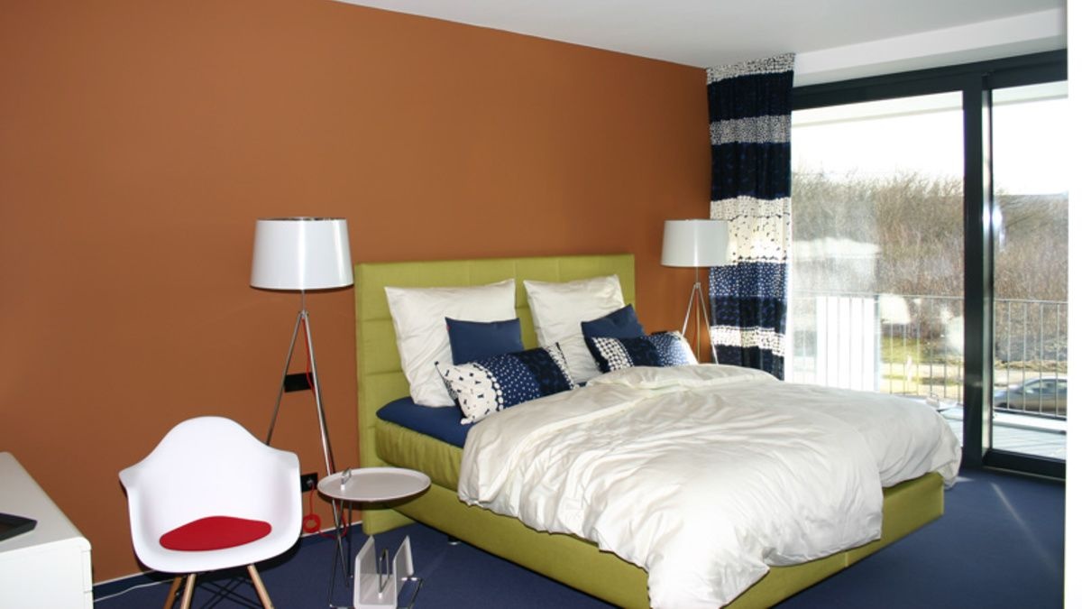 The Modern bedroom with a terracotta paint wall