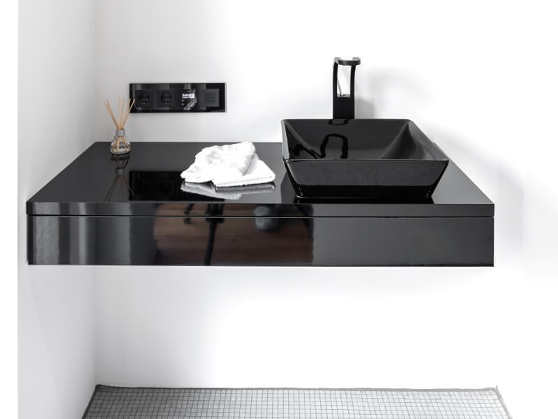 Black console locker under the sink in the style of high-tech