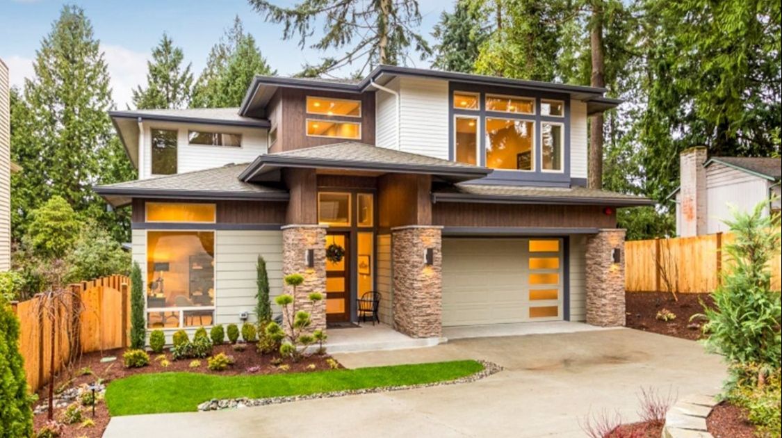 Modern two-story house with a hip roof with a covered veranda