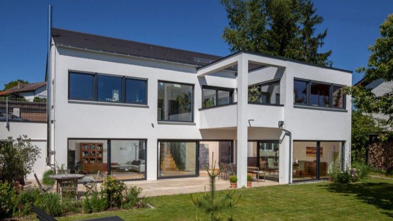 The clear, straight lines of this house plan with its extensive glazing are a clear indication of the modern, uncluttered style of the architecture. The interior layout is simple and compact, allowing for a variety of living spaces.