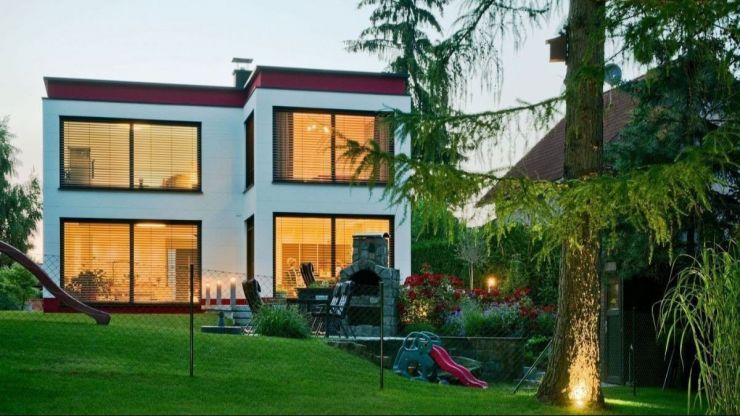 Contemporary two-story house plan made of aerated concrete with detached two car garage and three bedrooms on the second floor. House plan ideas for modern living.