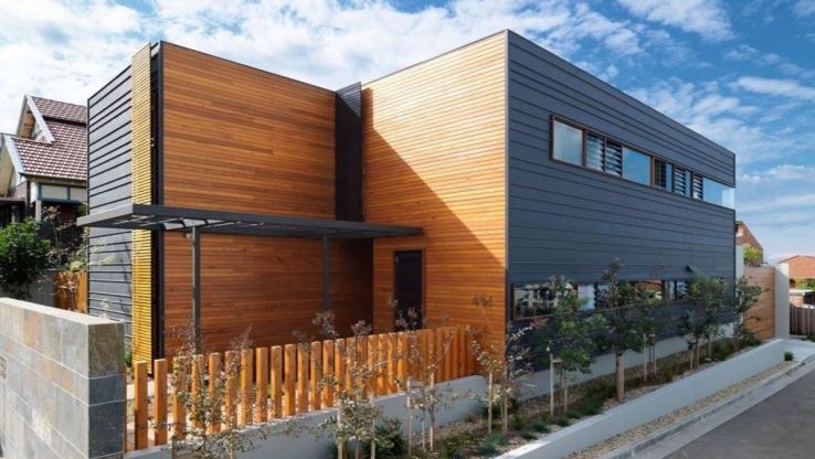 Two-story hi-tech house built in the factory and assembled on the site. It turned out a classy cottage with a swimming pool for the city. Project with interior photo.