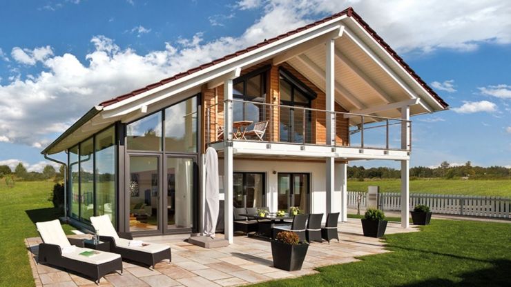 Beautiful two-story house plan in the Chalet style with large windows offers three bedrooms and a balcony on the second floor and open layout on the first floor.